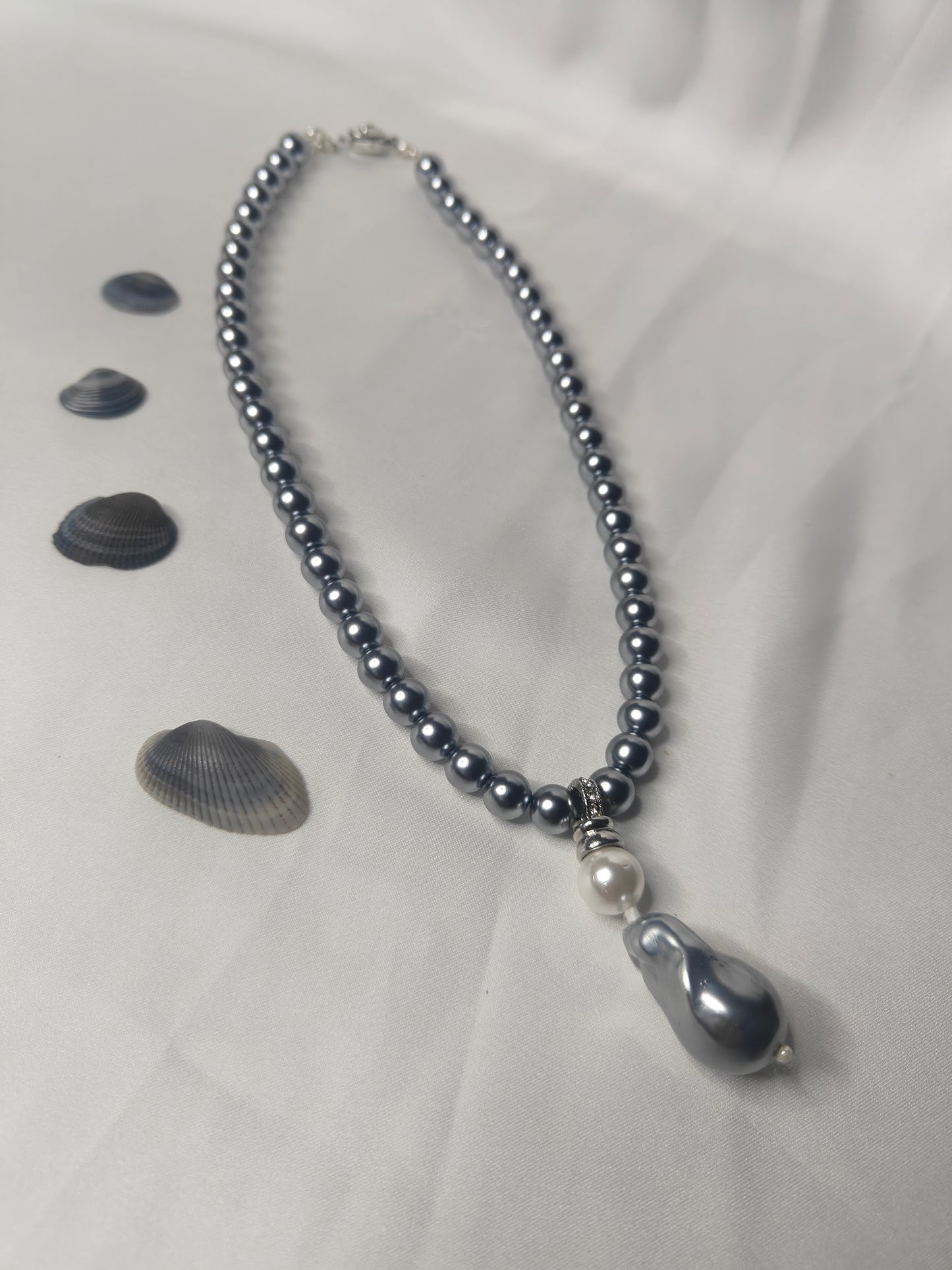 PSP006	Lunar Grace- Metallic grey single strand shell pearl necklace with Baroque pendant