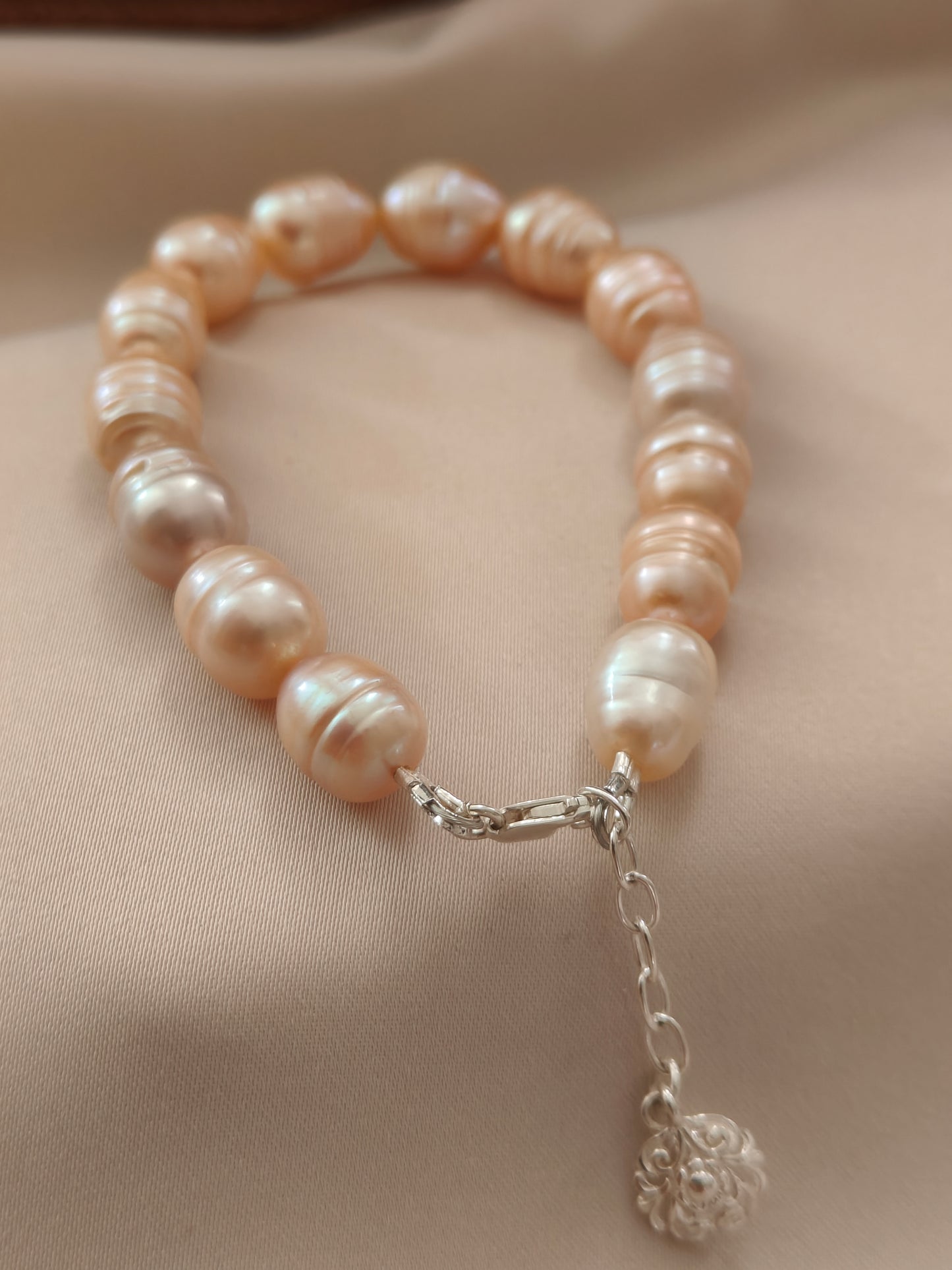 BRPFW002 Golden toned natural  ringed pearl bracelet with charm in sterling silver